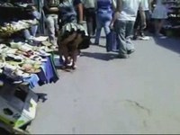 The babe in a very short dress is so fond of trying on new shoes at the street market that forgets about the panty peeping out as she bends over.